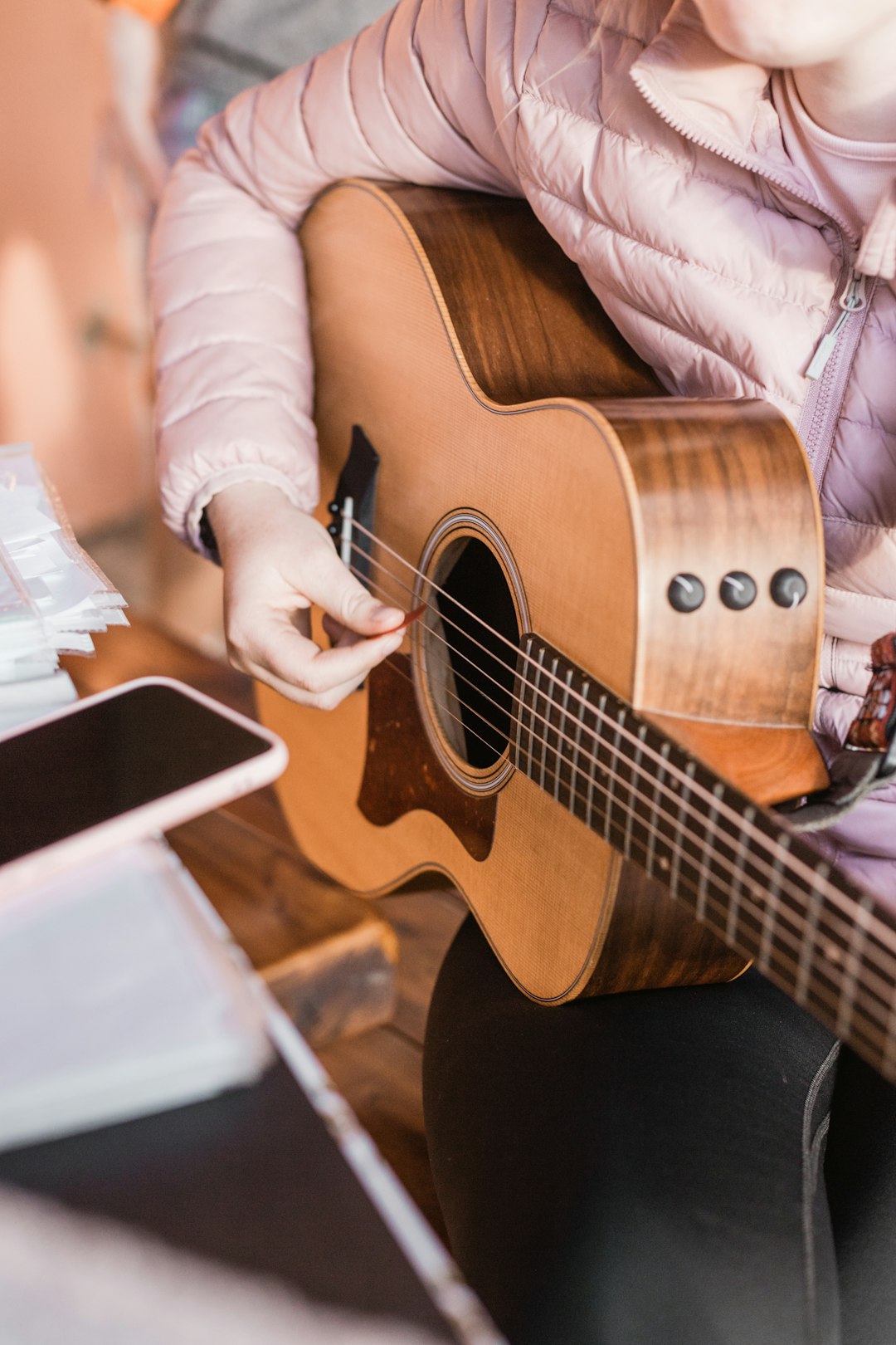 person-in-white-long-sleeve-shirt-playing-brown-acoustic-guitar-q8xh7geuzm0